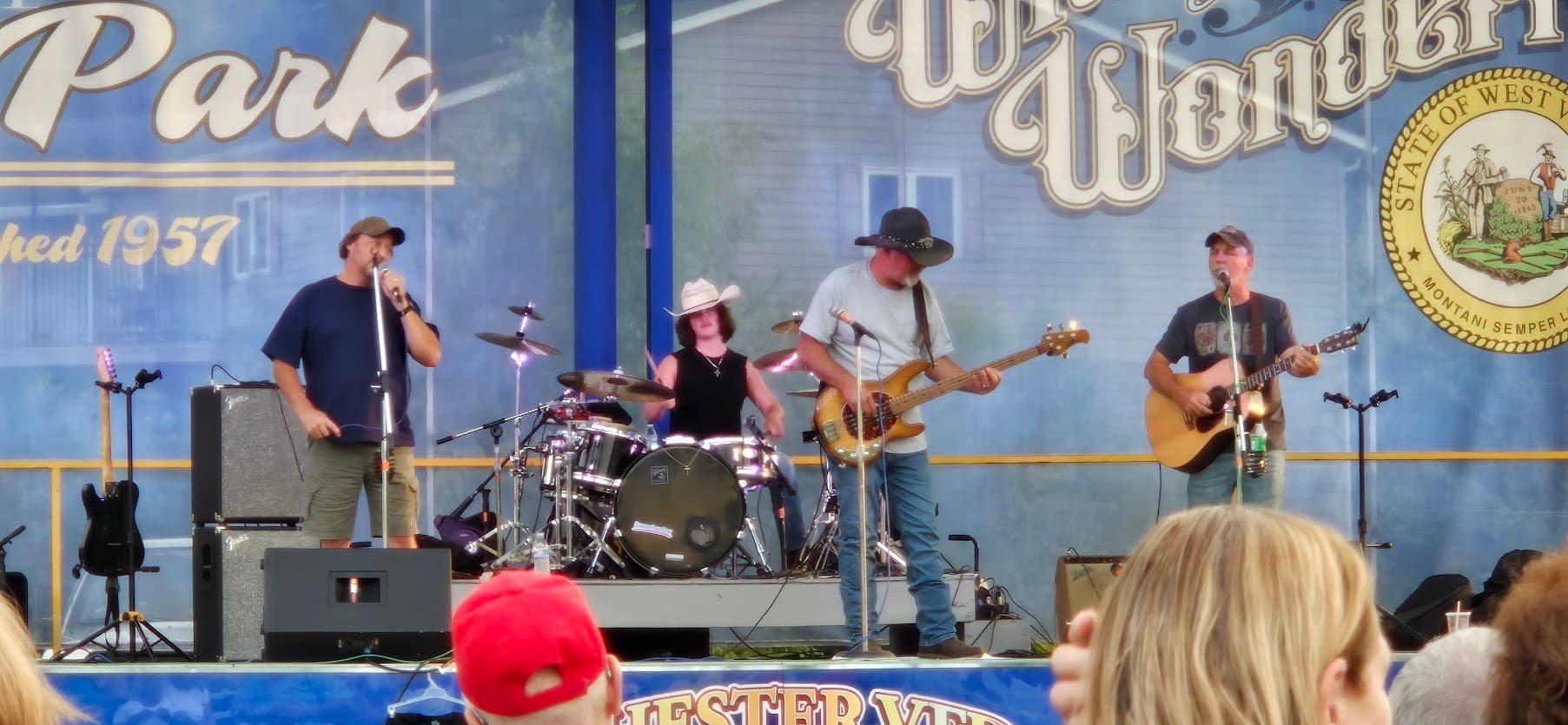 Tobe singing with the Wells Brothers band on the stage at Chester City Park.
